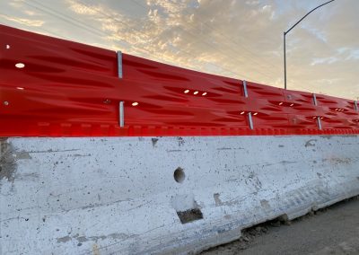 A Construction Glare Screen mounted on a concrete barrier as part of Traffic Safety products.