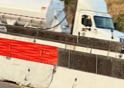 Temporary Traffic Screens in a highway construction zone showing wood panels versus BeltwayUSA orange gawk screens.